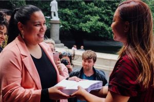 Melissa Lama presenting the Petition against “Armed Response Trials” at Parliament steps to Green Party co-leader Rt. Hon. Marama Davidson.