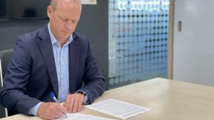 Chris James is signing the gazette notice to grant provisional approval for New Zealand’s use of the Pfizer and BioNTech COVID-19 vaccine Comirnaty - Ministry of Health image